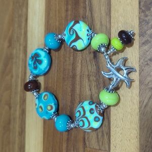 Sterling silver sun clasp and blue and brown glass bead artisan bracelet